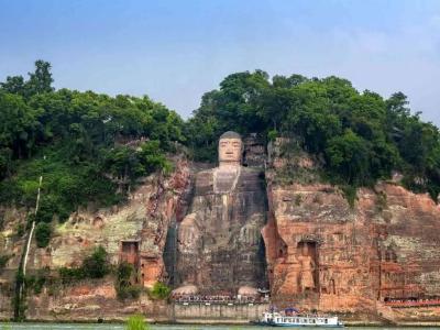 Full view of Leshan Giant Buddha carved on red sandstone cliff