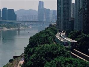 Chongqing city view with a metro train along the hillside, the Yangtze River, bridges and high-rise buildings
