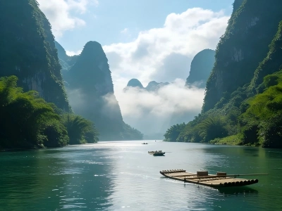 Bamboo raft on Li River, karst mountains surrounded by morning mist