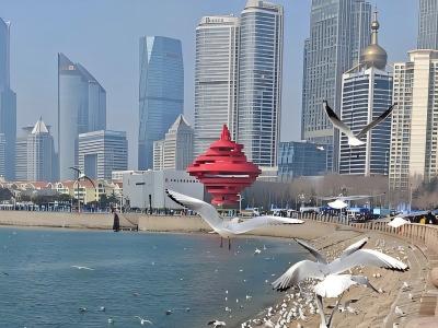 May Fourth Square in Qingdao with the red sculpture and modern skyscrapers along the waterfront