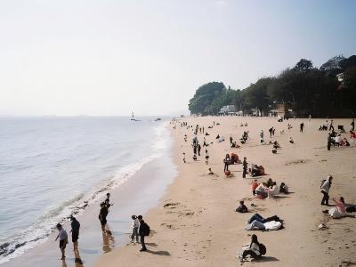 Gangzaihou Beach with sandy shore, visitors, and coastal scenery on Gulangyu Island