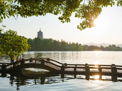 Sunset view of Leifeng Pagoda and wooden bridge over West Lake, Hangzhou China