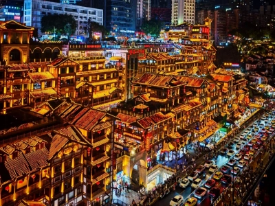 Stilt house complex lit up at night, traditional cliffside architecture, spectacular city nightscape in Chongqing China