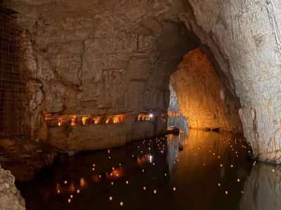 Huge natural Zhijin karst cave with underground river, warm lighting, Guizhou