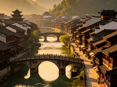 Fenghuang ancient water town with stone arch bridges and traditional buildings at sunrise