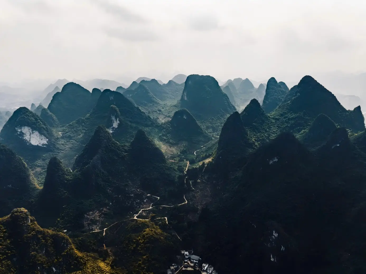 View of lush karst peaks of Guilin mountains with winding mountain roads