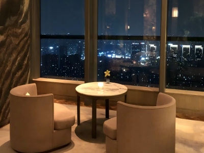 Quiet seating at Park Hyatt Hangzhou, panoramic Qianjiang CBD night view through tall glass