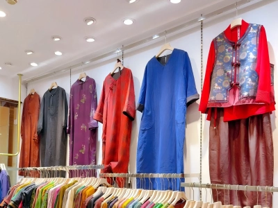 Colorful Chinese-style dresses and clothing hanging in a silk boutique