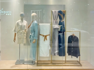 Silk pajamas and loungewear displayed in a boutique window with mannequins