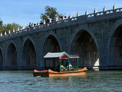 Stone bridge and boat scenery on Kunming Lake in the Summer Palace