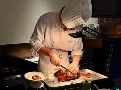 Chef preparing traditional Beijing roast duck in a Chinese restaurant