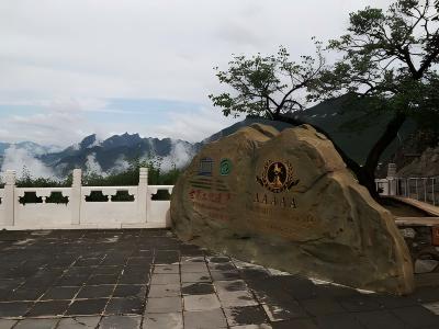 Mutianyu Great Wall scenic area entrance with mountain view and stone sign