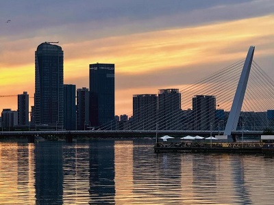 The calm waters and tall buildings of Houhai at dusk