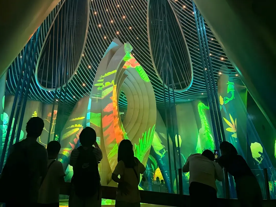 Tourists watch the tuned mass damper immersive digital show inside Shanghai Tower