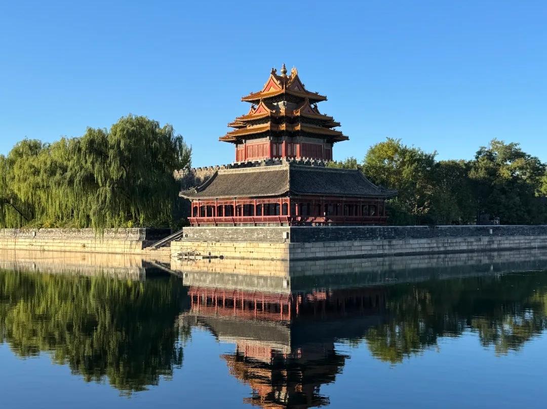 Ancient corner tower reflected in Forbidden City moat