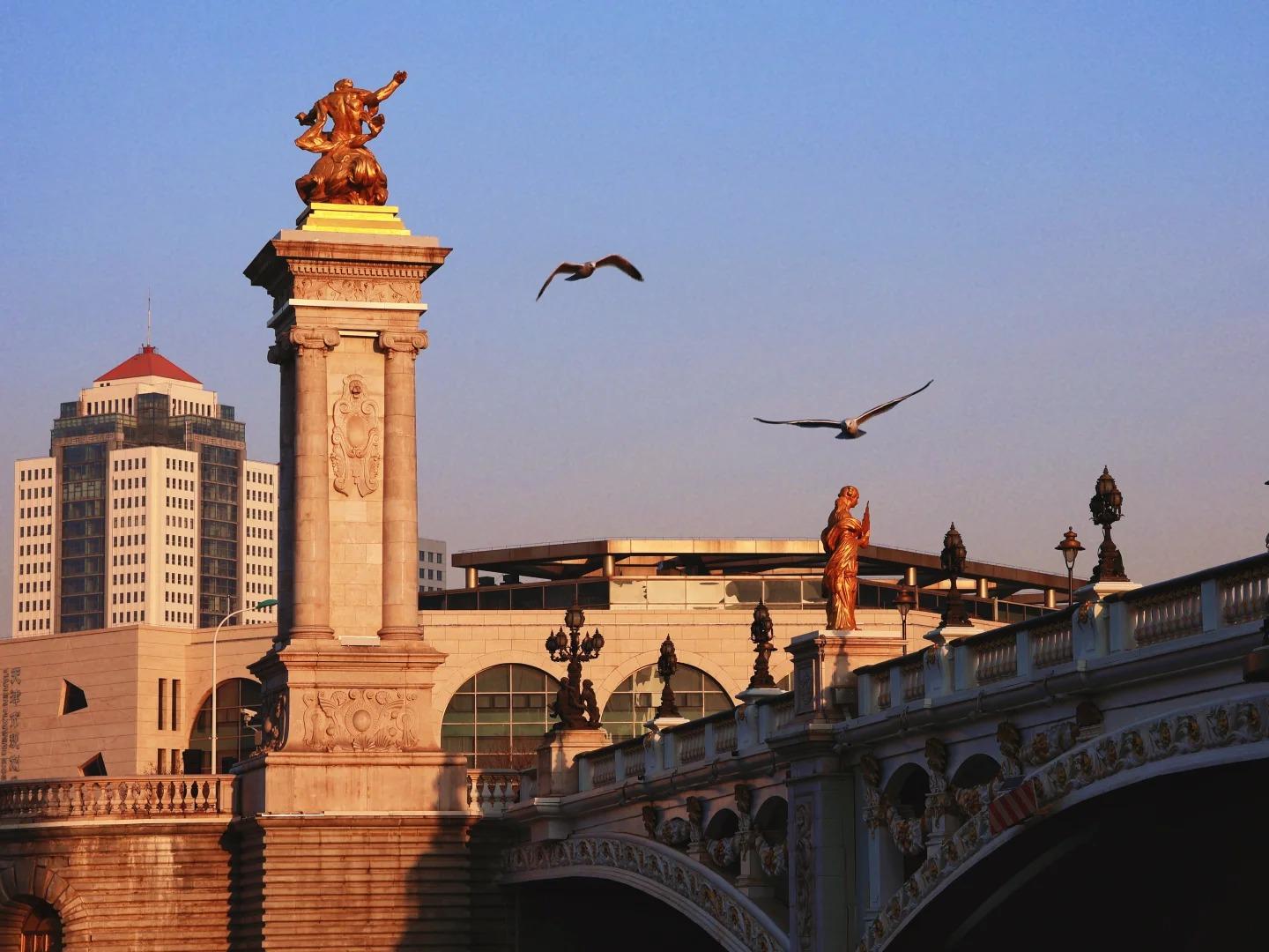 Ornate Beian Bridge with golden statues in Tianjin